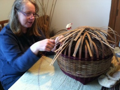 Leslie happily re-weaves her basket. 